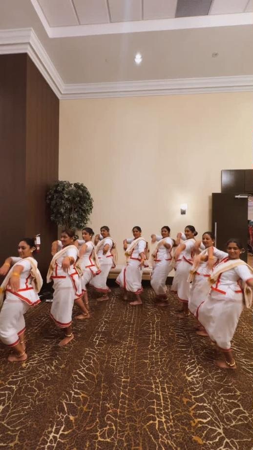Masakali dancers rehearsing a Kerala folk dance in white and red costumes